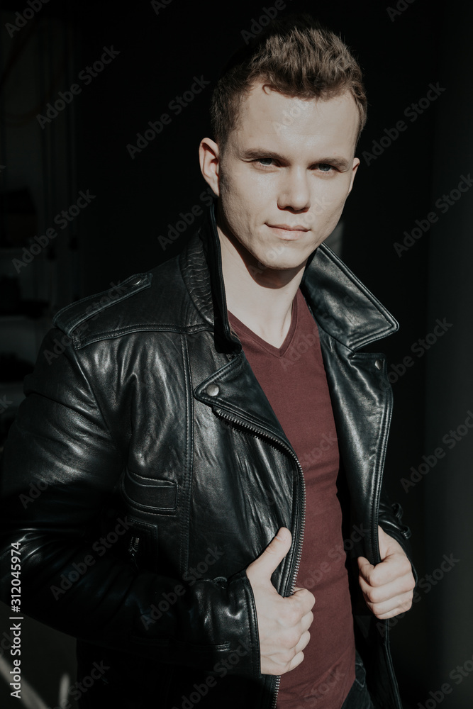 Obraz premium Portrait of a handsome young man in a black jacket
