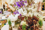 Bunch of flowers in a room, black tropical orchid, pink and purple flowers, white snowdrops, white background