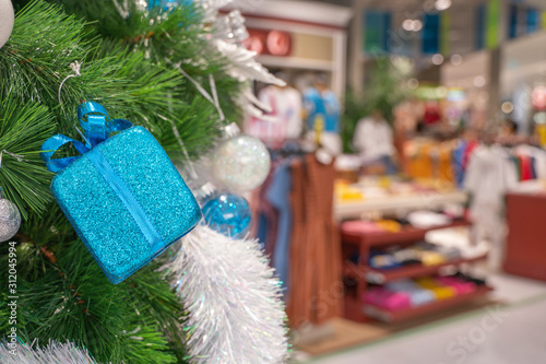 Beautiful Christmas gift boxes hanging from a decorated Christmas tree
