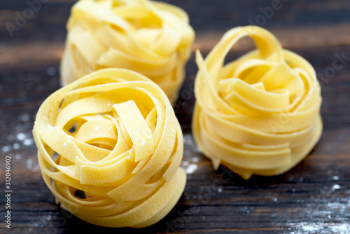 uncooked fettuccine nests close up