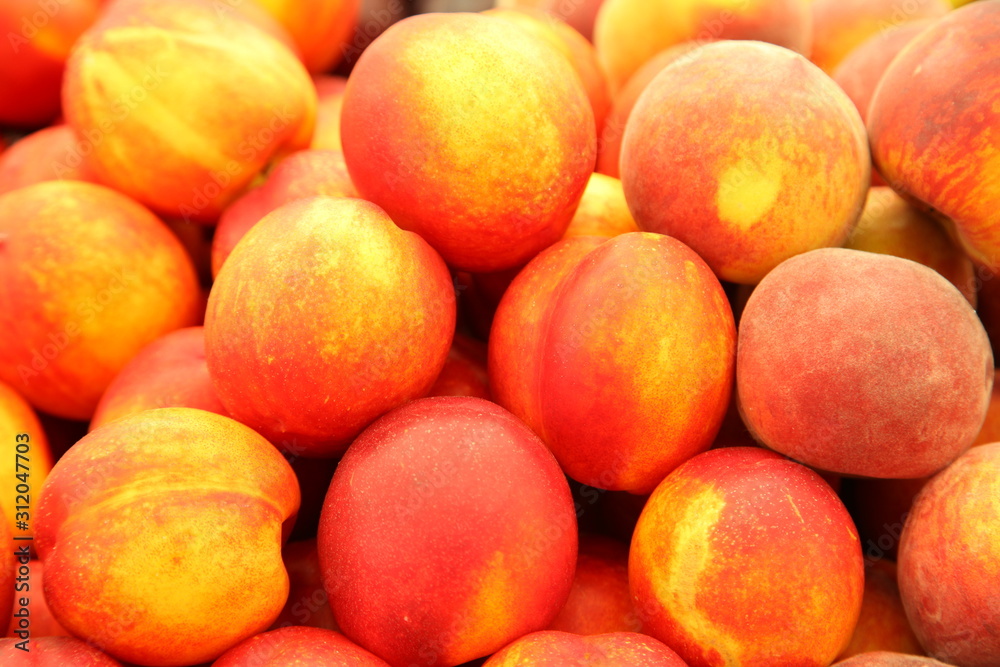 Lots of delicious looking very fresh peaches on sale at an outside market on a sunny Saturday. Lots of delicious looking very fresh peaches on sale at an outside market on a sunny Saturday.