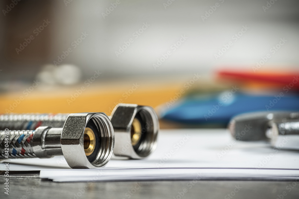 Flexible steel water hoses laying on table Flexible steel water hoses laying on table