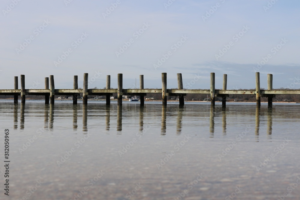Old weathered wooden dock on a sandy coastal