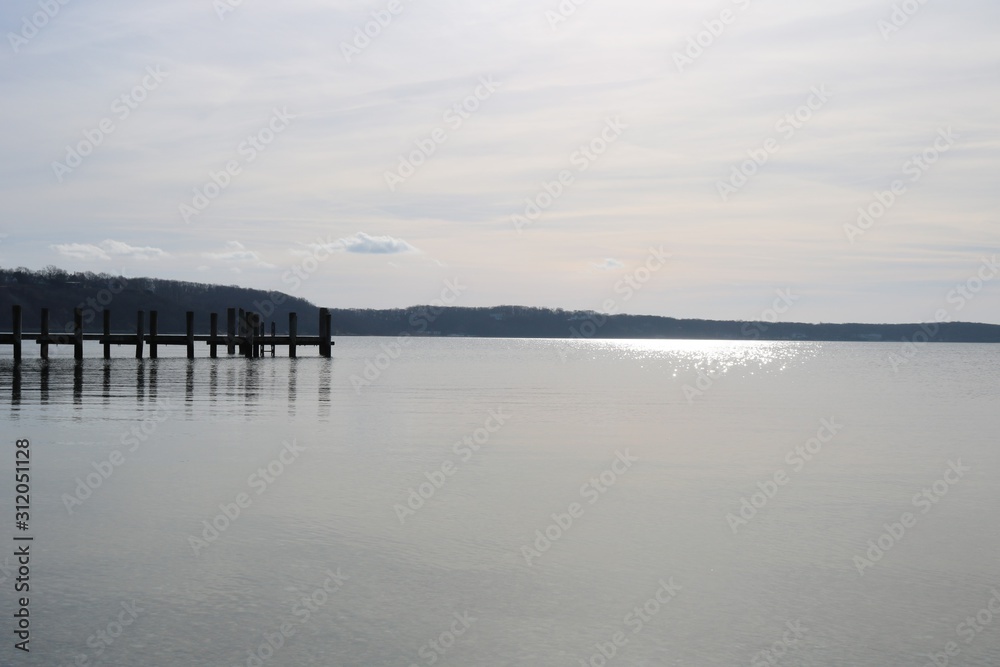 Old weathered wooden dock on a sandy coastal Old weathered wooden dock on a sandy coastal