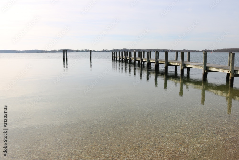 Old weathered wooden dock on a sandy coastal