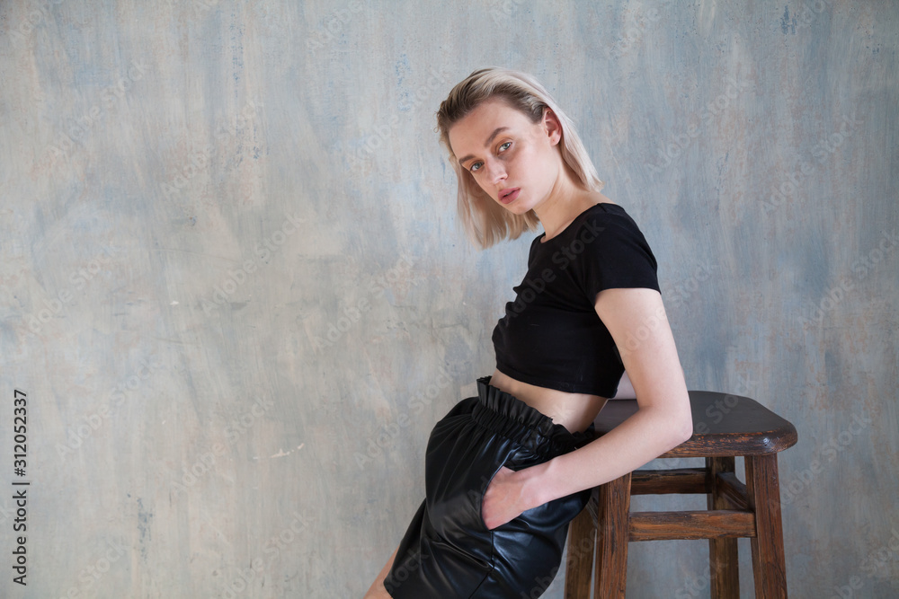 Fototapeta premium Portrait of a beautiful fashionable blonde woman in stylish clothes