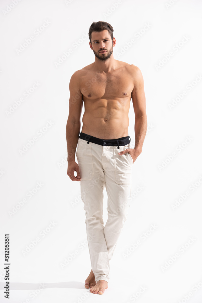 Fototapeta premium shirtless bearded man in white jeans on white