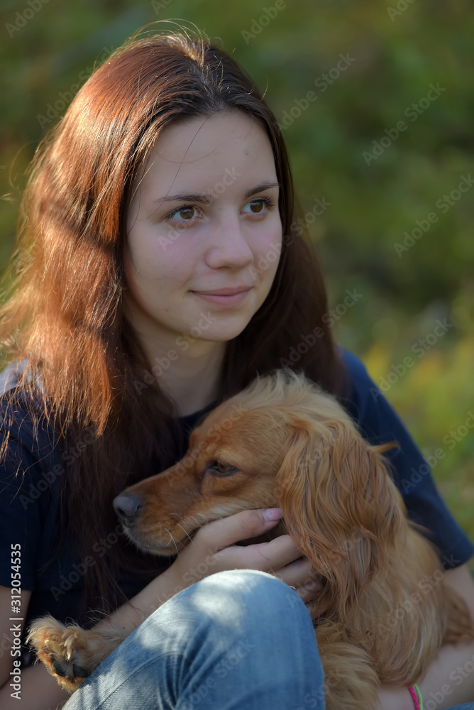 girl in forest with dog spaniel