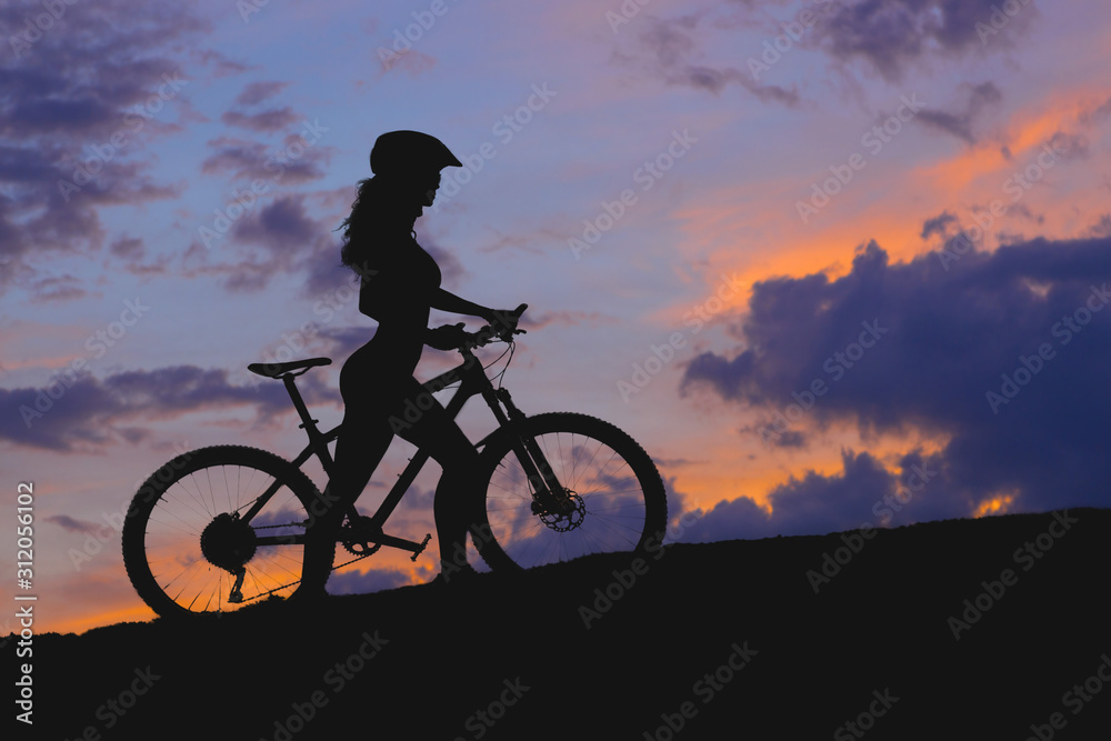 Obraz premium Conquering mountain peaks by cyclist in shorts and jersey on a modern carbon hardtail bike with an air suspension fork . Beautiful view from the mountain. Panoramic view for banner.