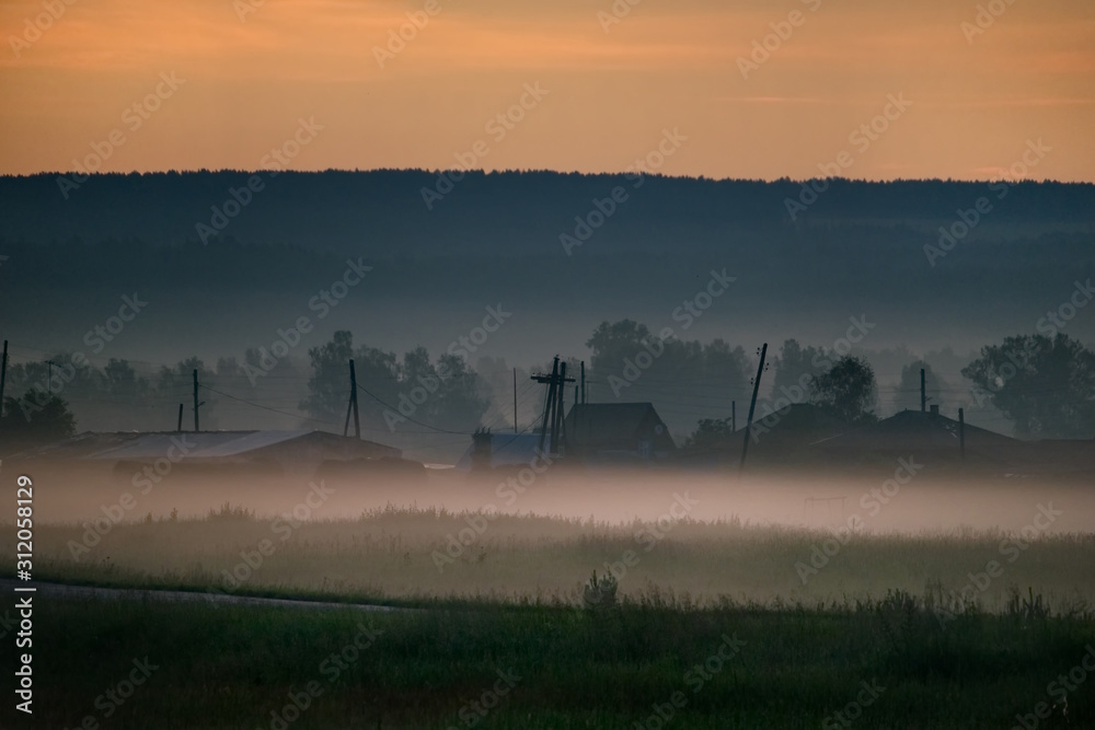 Fototapeta premium Russia. Republic Of Khakassia. Fog in the early summer morning in the fields near the city of Abakan.