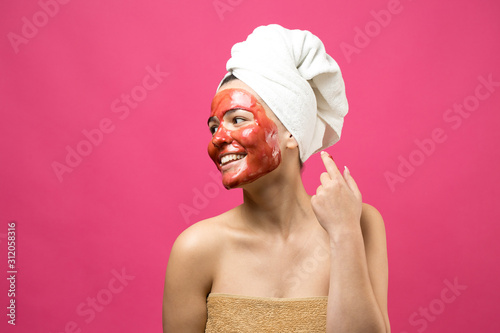 Beauty portrait of woman in white towel on head with gold nourishing mask on face. Skincare cleansing eco organic cosmetic spa relax concept.