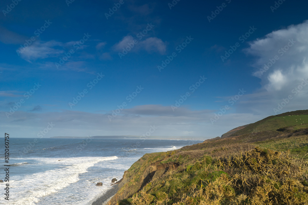 Coast path leading into Westward Ho on the North Devon coast of England looking across Bideford Bay 