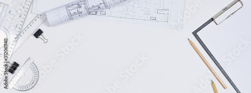 Architectural plans, pencil and ruler on the table. Working surface. Place for your text. View from above. photo