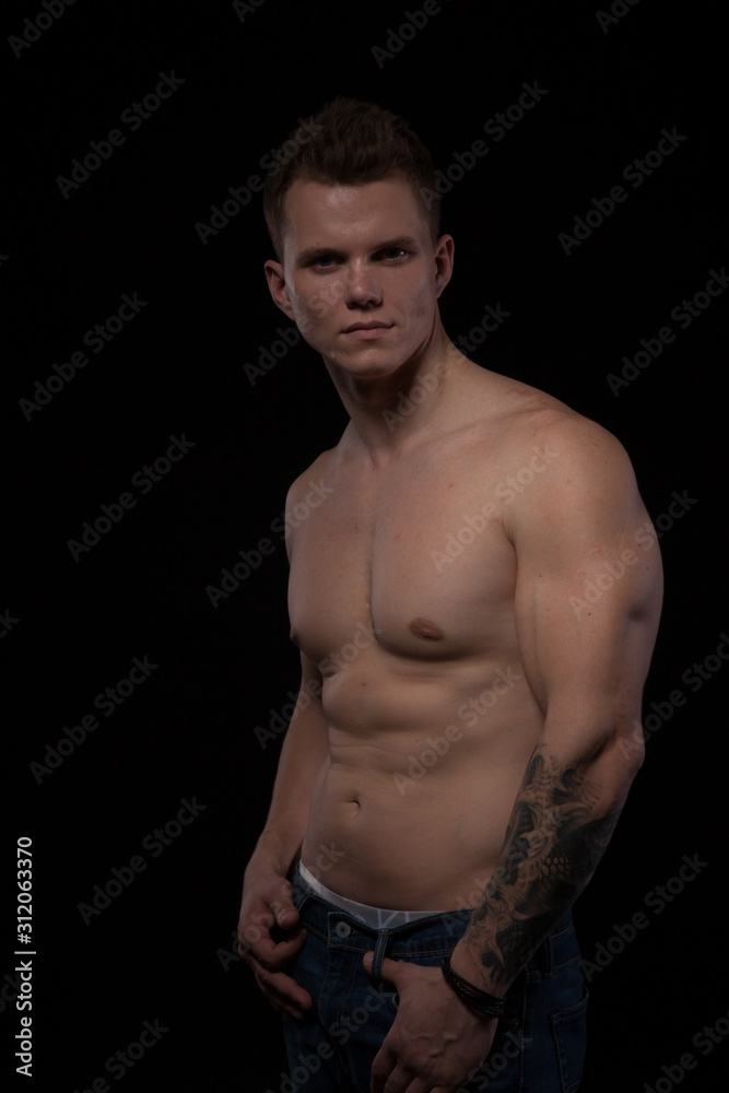 Fototapeta premium portrait of a beautiful fashionable strong man with a bare torso