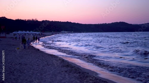 Beach at Sopot, Poland at sunset time, with waves coming to shore