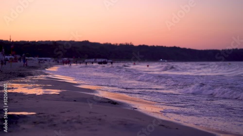Beach at Sopot, Poland at sunset time, with waves coming to shore