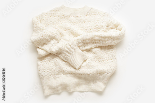  Warm knitted sweater on white background. Minimalistic flatlay