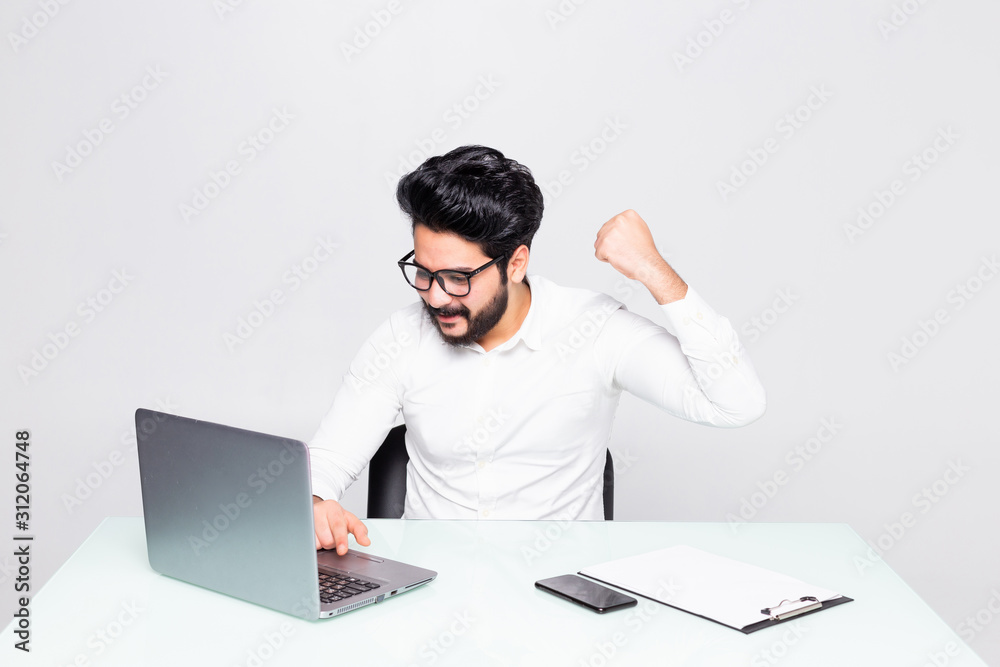 Young businessman working with laptop over white background Young businessman working with laptop over white background