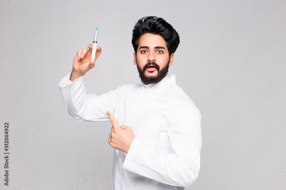 Happy young doctor holding syringe isolated on white background