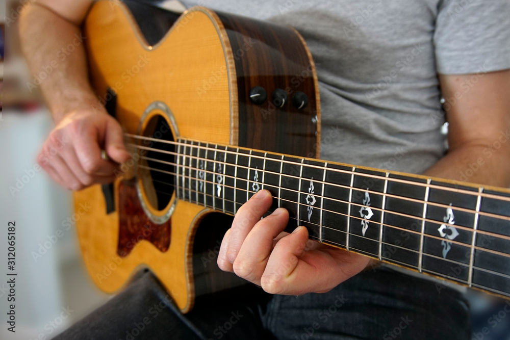 Close-up on guitarist's fingers on the guitar fretboard