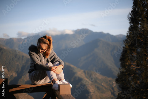 a women wearing a winter coat watching the view and beautiful nature in landscape in Taiwan