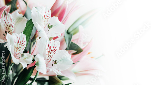 Bouquet of white alstromeria flowers and pink lilies close-up on a white background. Floral spring background with free space for text, copy space. Composition with beautiful blooming flowers. photo