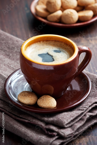 Coffee cup with vanilla cookies on wooden table