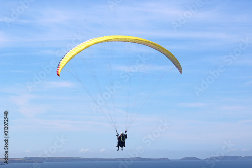 Tandem paraglider flying at Newgale, Wales 