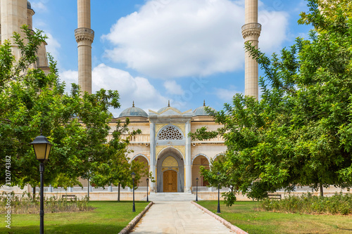 Turkey's largest Sabanci Central Mosque in Adana among bright foliage of trees