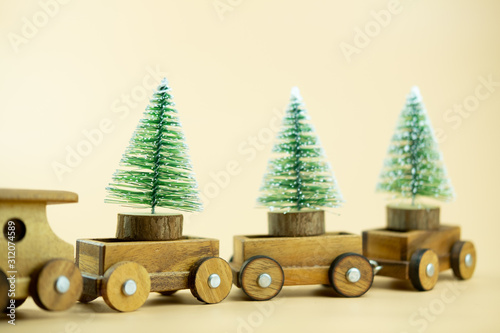 Wooden toy train carry on Christmas tree. photo