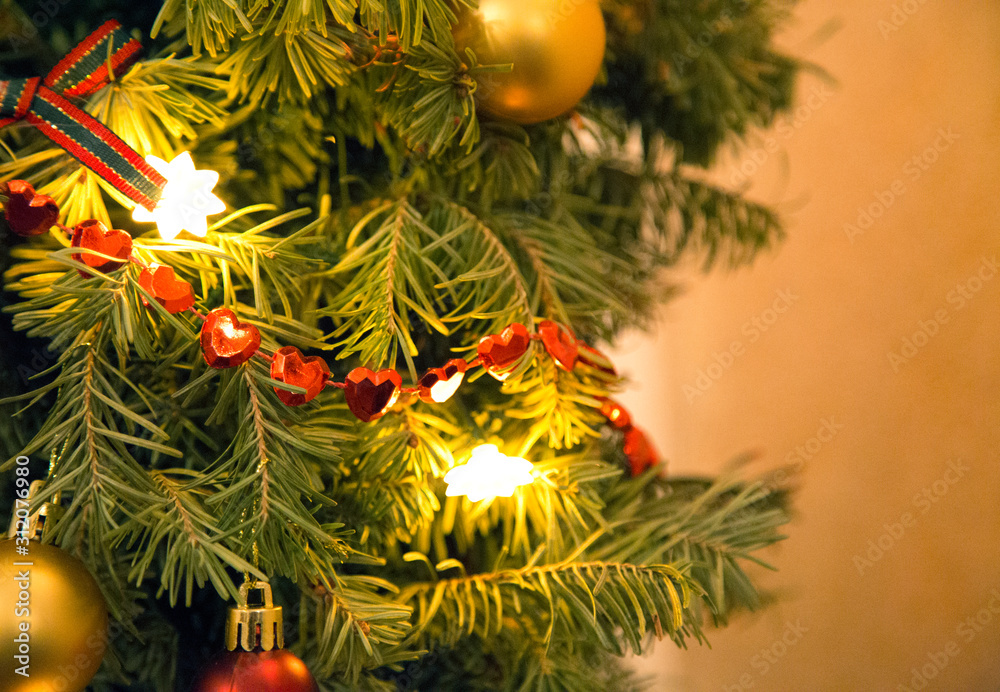 fragment of Christmas tree decorated with balls and heart-garland fragment of Christmas tree decorated with balls and heart-garland