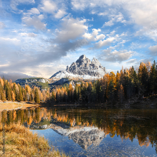 Beautiful landscape of alpine lake under bright sunlight. Incredible nature Landscape of Dolomites Alps. Impessive Beautiful View on Mountain Lake Antorno in Autumn. popular Travel destination