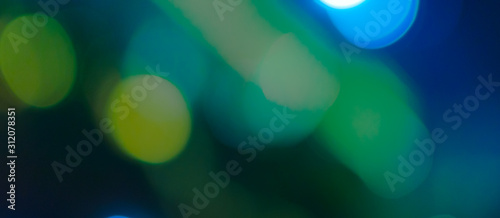 Abstract Bokeh Blue and green background of defocused glittering lights. Christmas, Party, New Year, luxurious background pattern concept. banner.