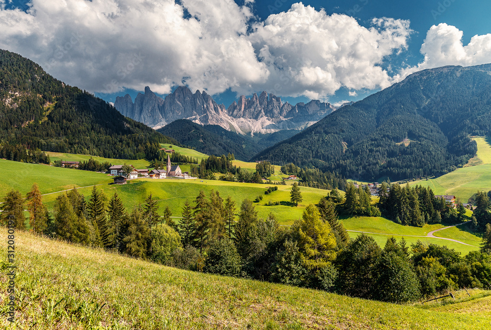 Awesome alpine Landscape in sunny day. Santa Maddalena.  Is one of the most popular photo spot of Dolomite. Famous World place. Dolomites Alps. Italy.  Amazing Natural background. Postcard