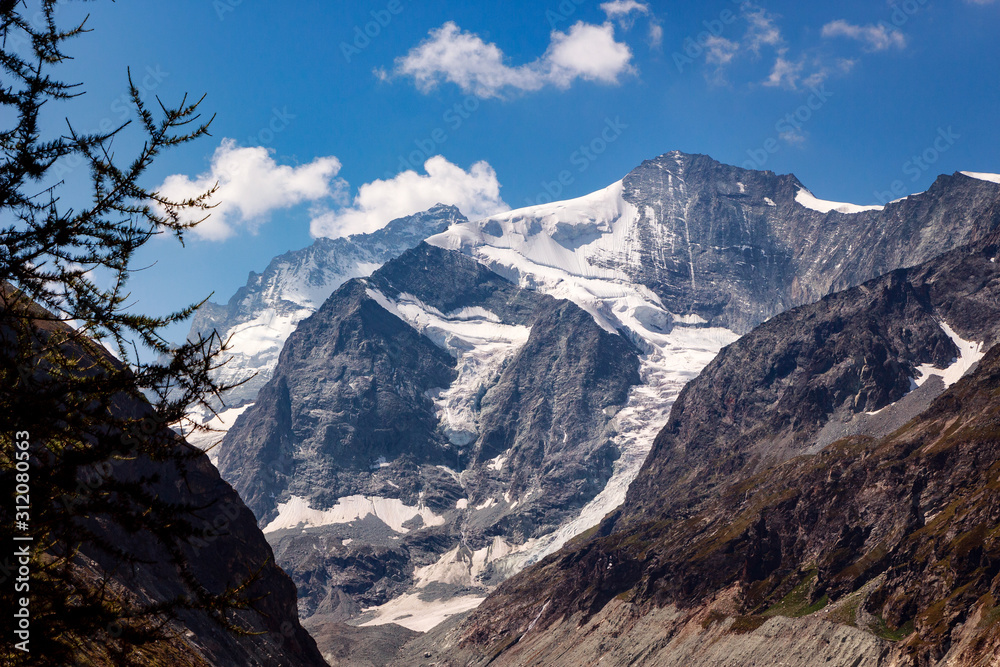 view on majestic high mountain peaks covered in snow and glacial ice in the Pennine Alps near Val d' Anniviers, Valais, Switzerland