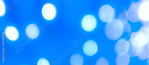 Abstract Bokeh Blue and green background of defocused glittering lights. Christmas, Party, New Year, luxurious background pattern concept. banner.