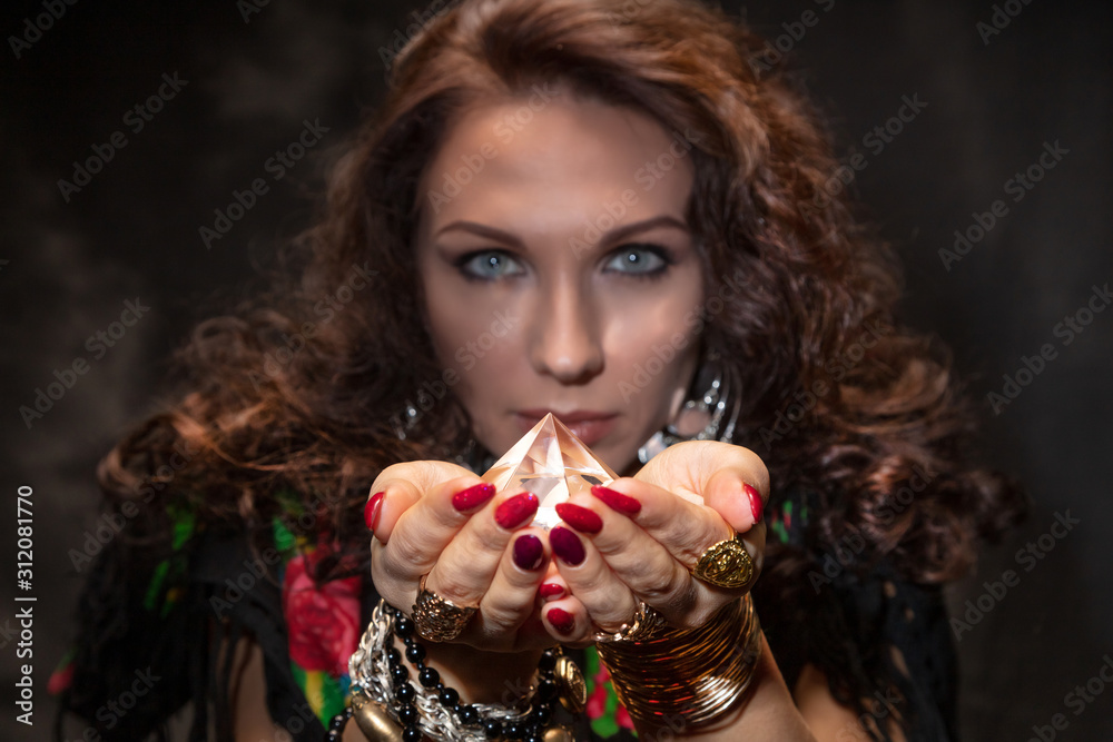 Fortune teller with a magic stone. Romantic magic. Palmistry. Clairvoyance Fortune teller with a magic stone. Romantic magic. Palmistry. Clairvoyance