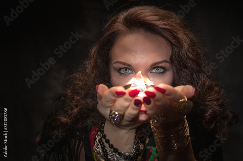 Fortune teller with a magic stone. Romantic magic. Palmistry. Clairvoyance photo