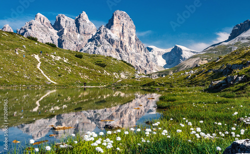 Amazing Dolomites Mountains. Landscape with calm mountains lake and bluel sky. Wonderful Nature Landscape in summer. Incredible view of Dolomites Alps. Tre Cime di Lavaredo National park. Italy.