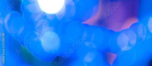 Abstract Bokeh Blue and green background of defocused glittering lights. Christmas, Party, New Year, luxurious background pattern concept. banner.