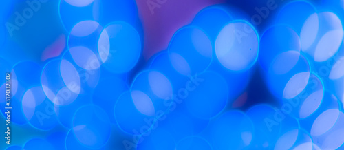 Abstract Bokeh Blue and green background of defocused glittering lights. Christmas, Party, New Year, luxurious background pattern concept. banner.
