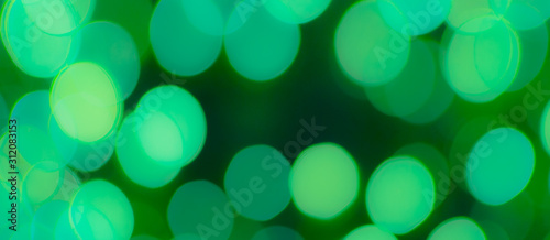 Abstract Bokeh Blue and green background of defocused glittering lights. Christmas, Party, New Year, luxurious background pattern concept. banner.