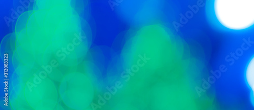 Abstract Bokeh Blue and green background of defocused glittering lights. Christmas, Party, New Year, luxurious background pattern concept. banner.