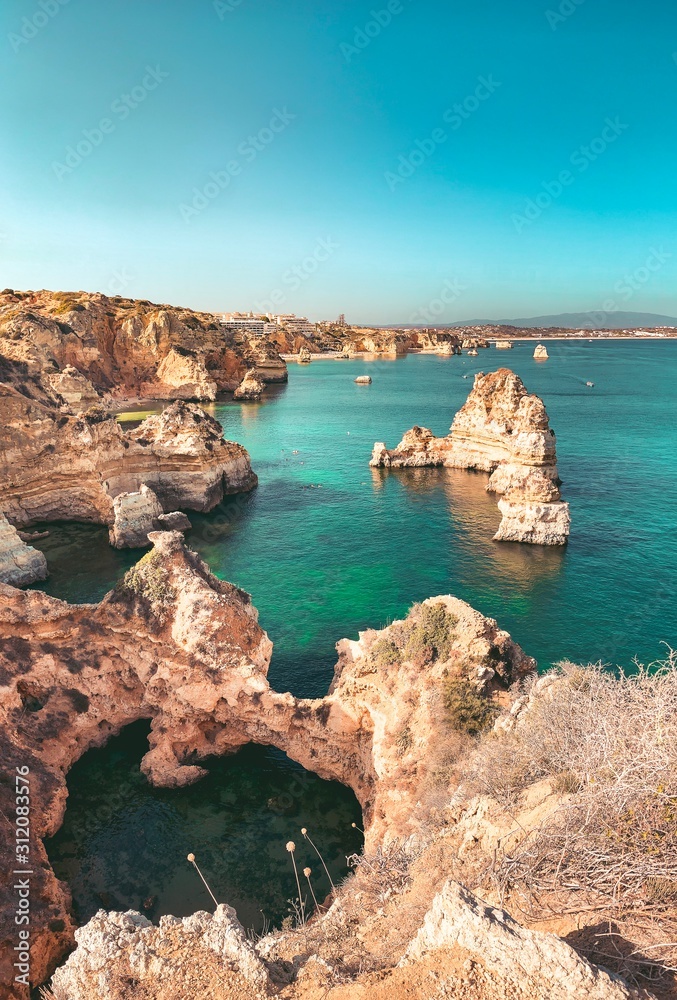 The famous cliffs and rocks in the ocean from a viewpoint over the ocean at sunset light. Perfect spot for travel ideas in europe. Farol da Ponta da Piedade, Lagos, Faro, Portimão, Algarve, Portugal
