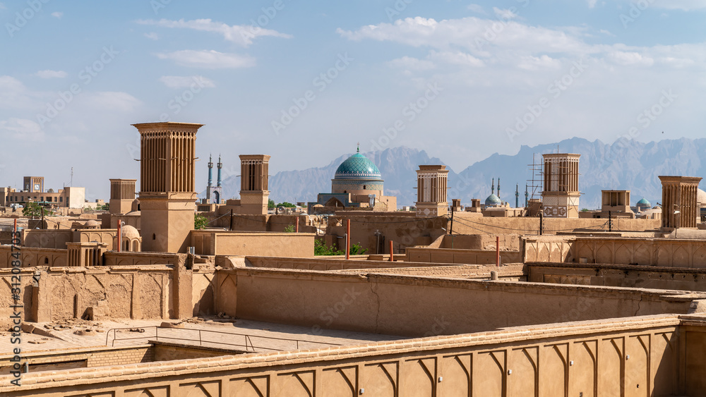 Yazd cityscape with old brick buildings and badgirs wind catching towers in Yazd, Iran.