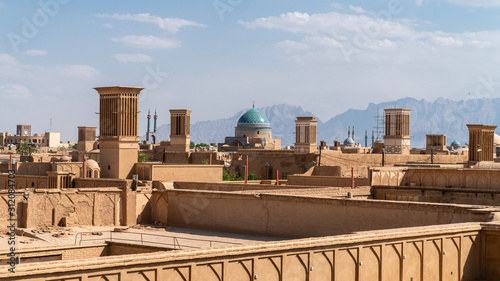 Yazd cityscape with old brick buildings and badgirs wind catching towers in Yazd, Iran. photo