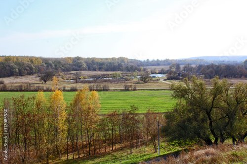 Fototapeta Naklejka Na Ścianę i Meble -  Autumn landscape with fields, trees and hills.