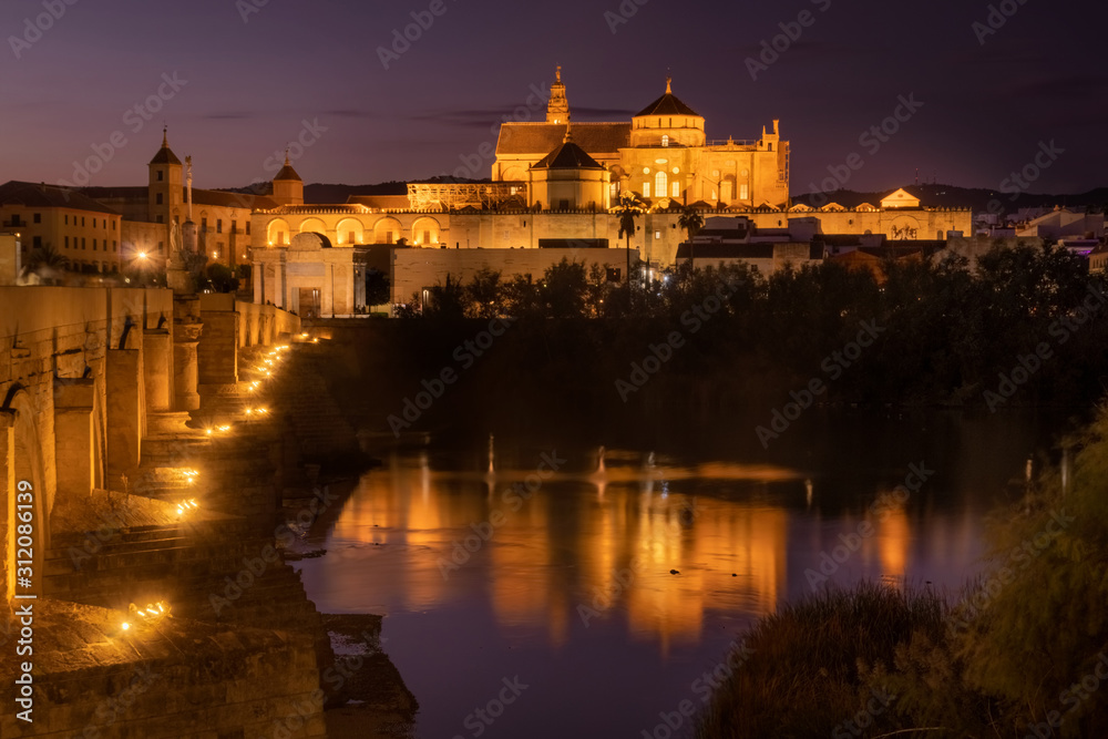 Roman Bridge and Guadalquivir river after the sunset, Great Mosque, Cordoba, Spain