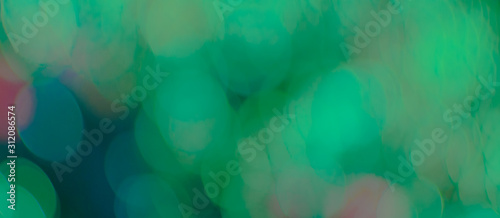 Abstract Bokeh Blue and green background of defocused glittering lights. Christmas, Party, New Year, luxurious background pattern concept. banner.