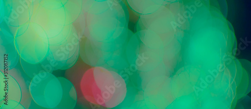 Abstract Bokeh Blue and green background of defocused glittering lights. Christmas, Party, New Year, luxurious background pattern concept. banner.